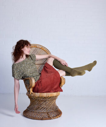 Person seated in a decorative chair.